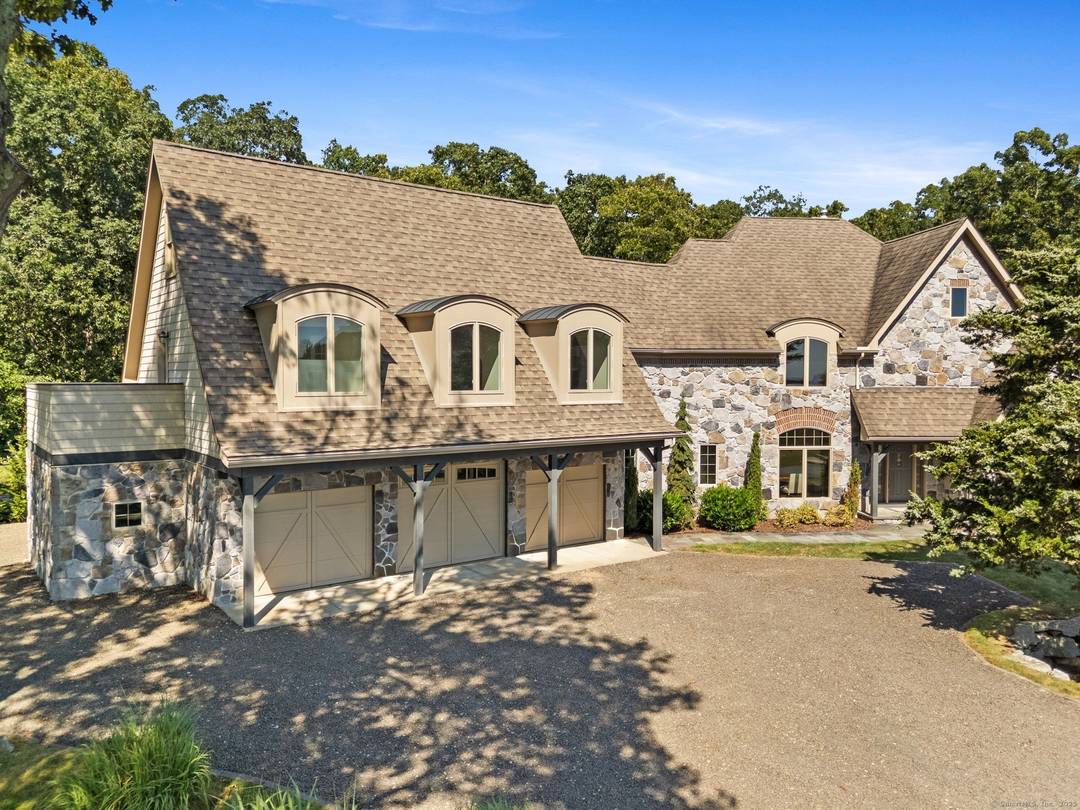 Experience upscale living in this stunning contemporary home, perfectly perched on a hillside with sweeping views across the Mystic River Valley to the waters of Fishers Island Sound.