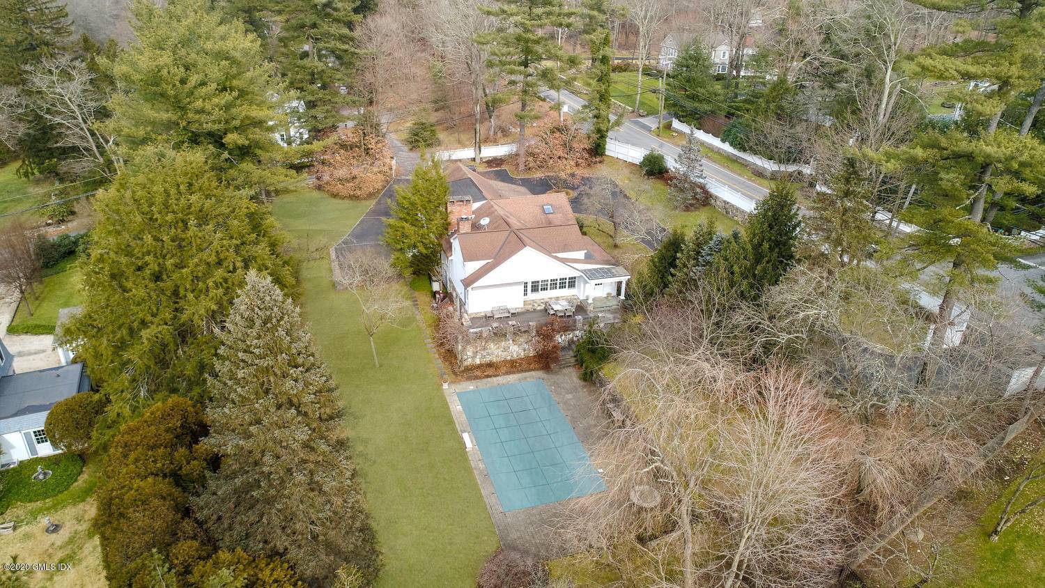 Stone walls abound this elegant country home set off Stanwich Road, and walking distance to Greenwich Country Day School.