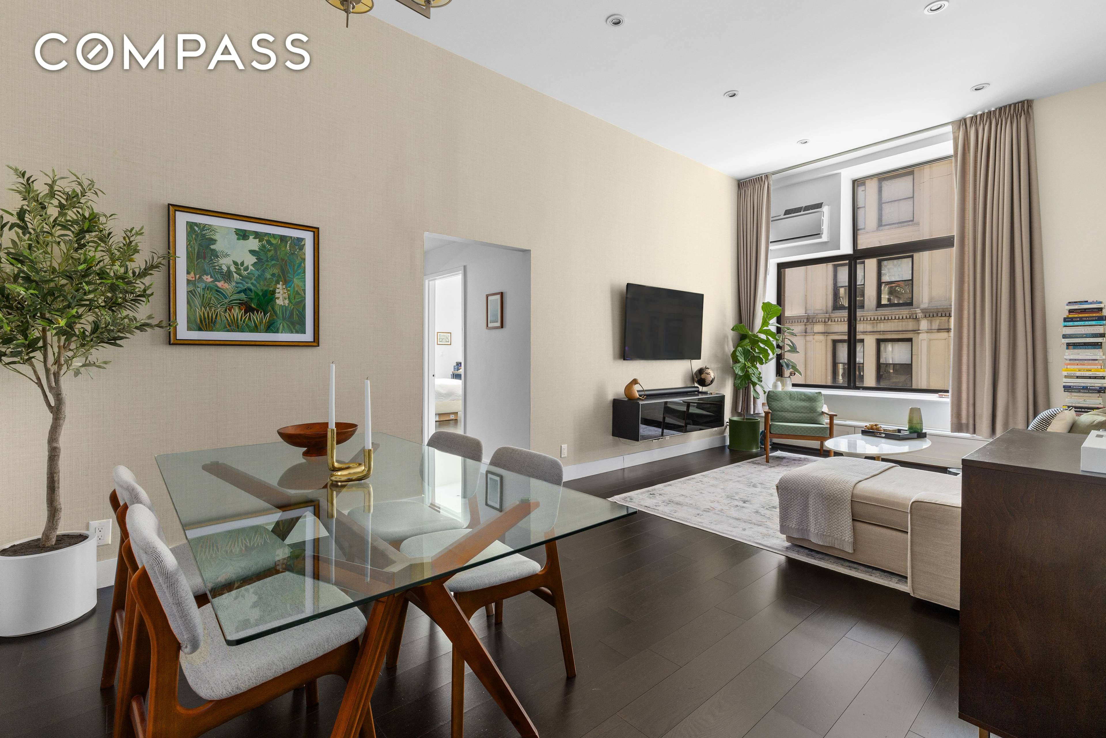 Welcome to this mint condition showstopper with soaring 12 foot ceilings and a wall of oversized windows that flood the space with incredible southern light.