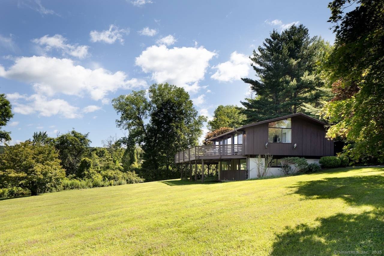 This distinctive mid century modern Deck House commands seasonal mountain views across the rolling landscape of Northwest Connecticut's Litchfield Hills.