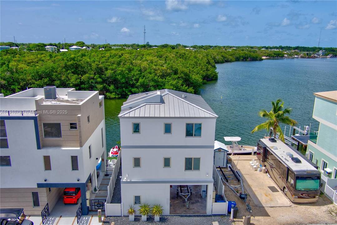 This stunning three story waterfront home offers panoramic ocean views from every level and a private elevator for effortless access.