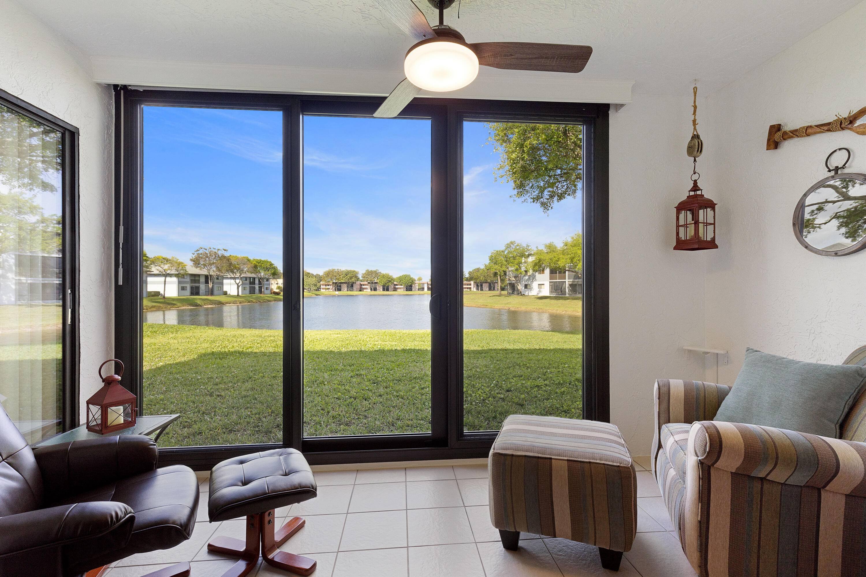 Spectacular long lake view from this beautiful 2 bedroom 2 bath first floor condo in Lakes of Delray.