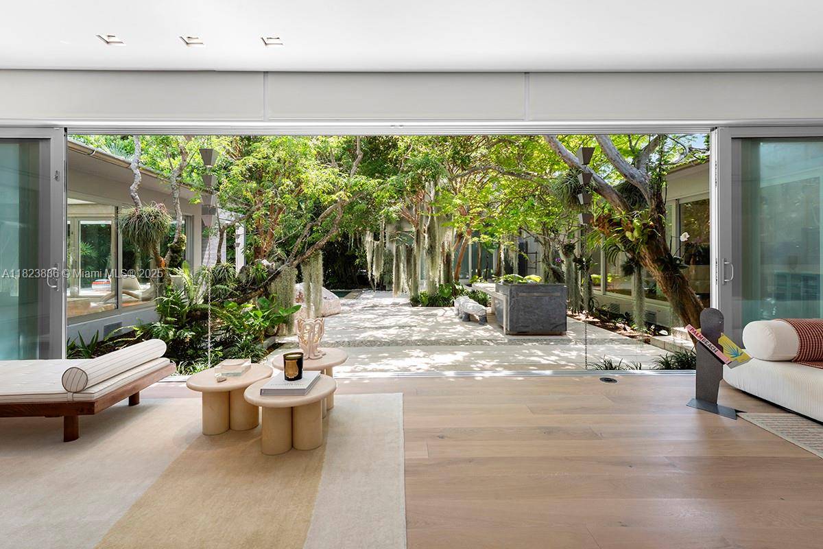 Tucked away on La Gorce Island, this artful Mid Century Modern home offers refined living w tropical serenity.
