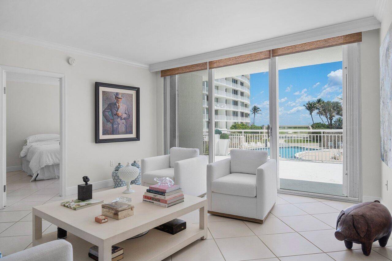 Rarely available sun drenched corner unit with a sprawling 600 sq ft lanai offering panoramic views of the ocean and saltwater pool perfect for entertaining or relaxing in style.
