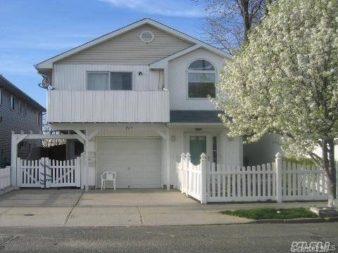 Built Only 27 Years Ago, A Spectacular Contemporary Two Family Home with Cathedral Ceiling, Skylight, Beautiful Hardwood Floors, Pvt Fenced Yard, Full Finished Garage amp ; 2 Driveways.