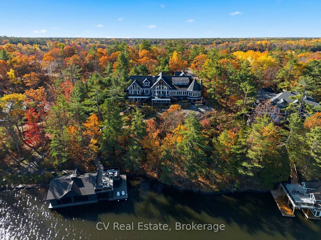 Rising above the shoreline of Lake Muskoka, this extraordinary estate captures sweeping views across Muskoka Bay from a spectacular private setting, delivering grand scale architecture.