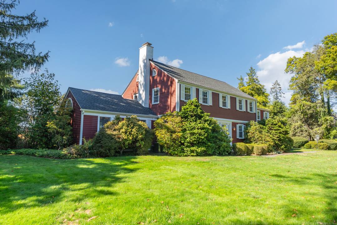 Beautifully bright and sunny Center Hall Colonial set back from the street on a beautifully landscaped 0.