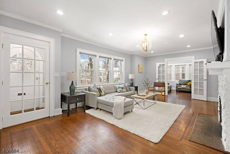 This classic Tudor in West Orange's coveted Gregory section welcomes you with its distinctive red front door and timeless architectural charm.