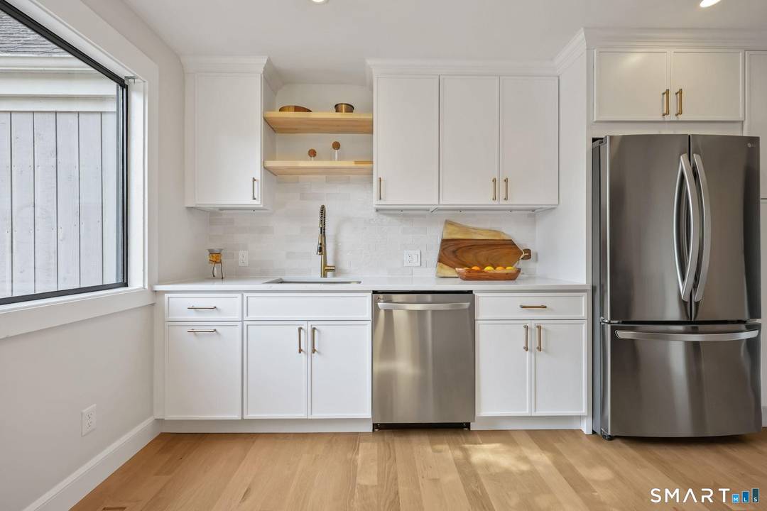 Welcome to effortless Oronoque Village living in this beautifully remodeled Wolcott style end unit, tucked away on a quiet cul de sac within the coveted North Trail complex.