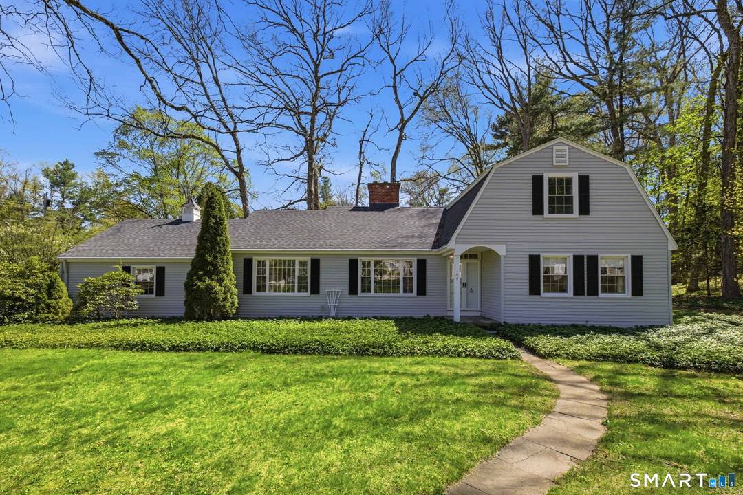 Charming, light filled Cape on a lightly wooded corner lot !