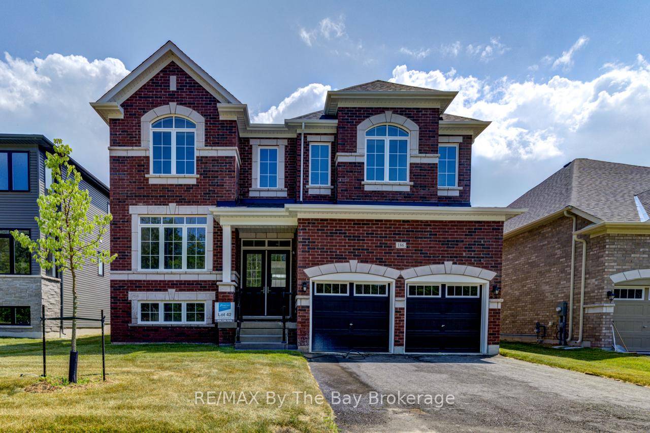 All brick 'Anchor' model by Zancor Homes with a separate entrance to the basement.