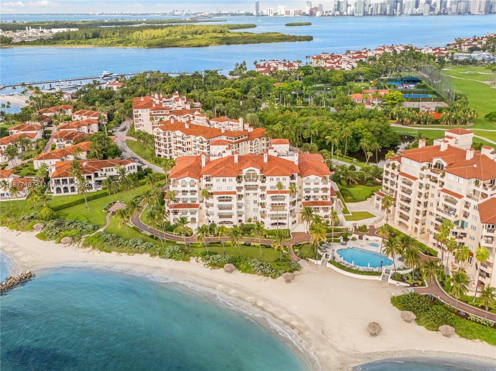 Positioned on one of Miami s most exclusive addresses, this Fisher Island residence combines two corner homes into one expansive sanctuary.