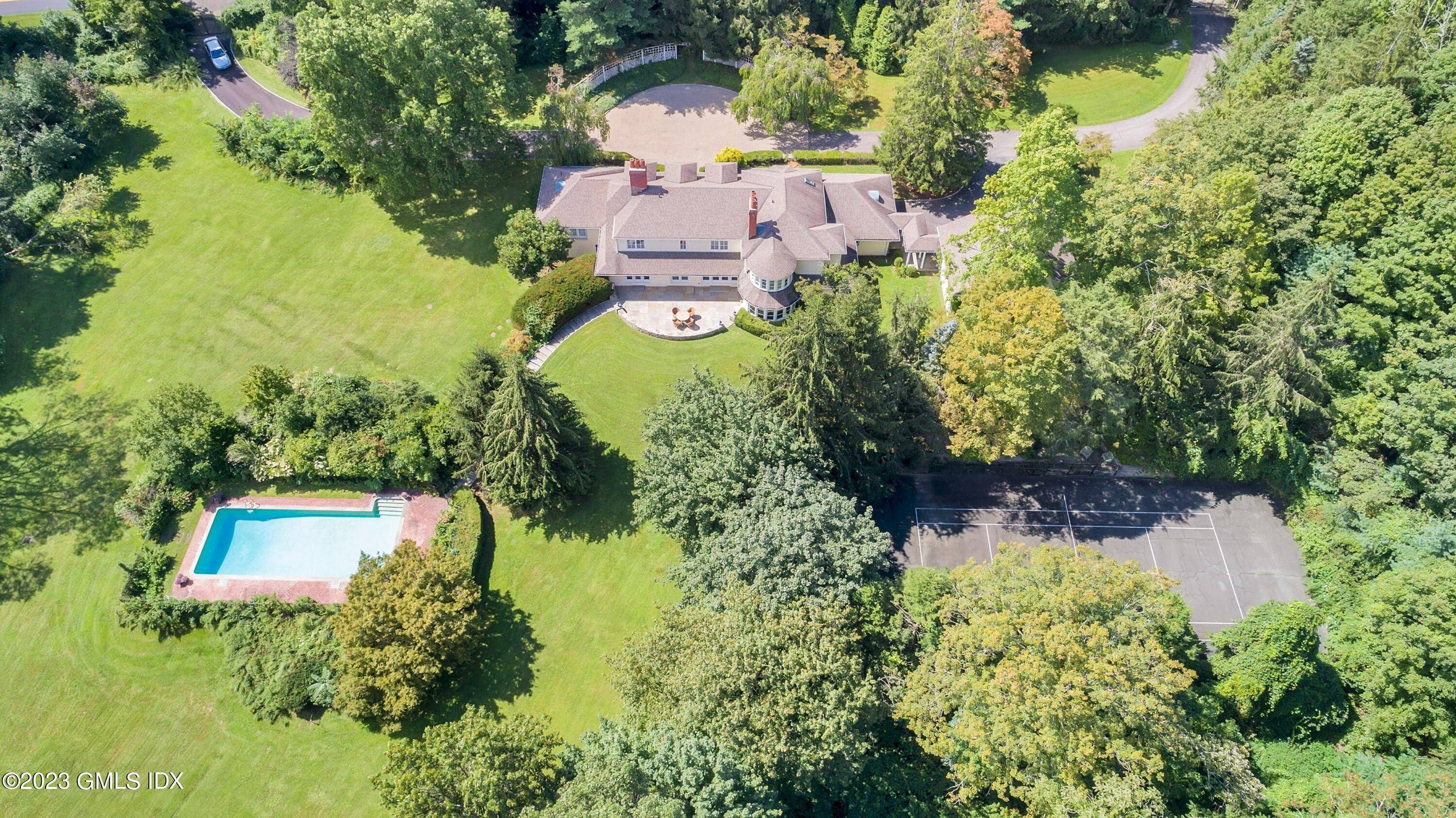 Picture perfect 4. 2 acres boasts sophisticated, completely renovated Colonial with stone terrace, pool and tennis court on desirable mid country road.