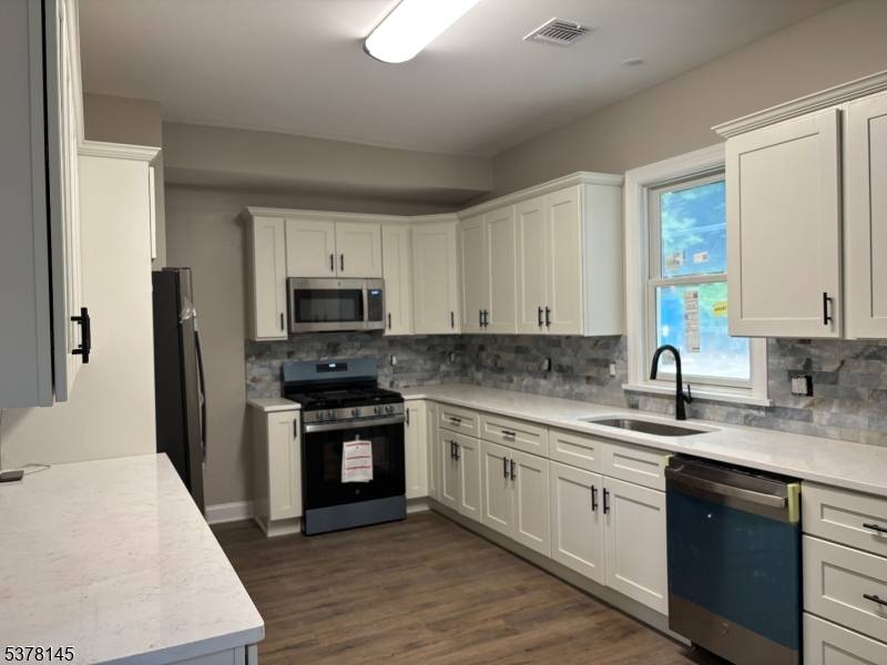 HUGE, COMPLETELY RENOVATED 5 BEDROOM TOWNHOUSE with 3 FULL BATHROOMS.