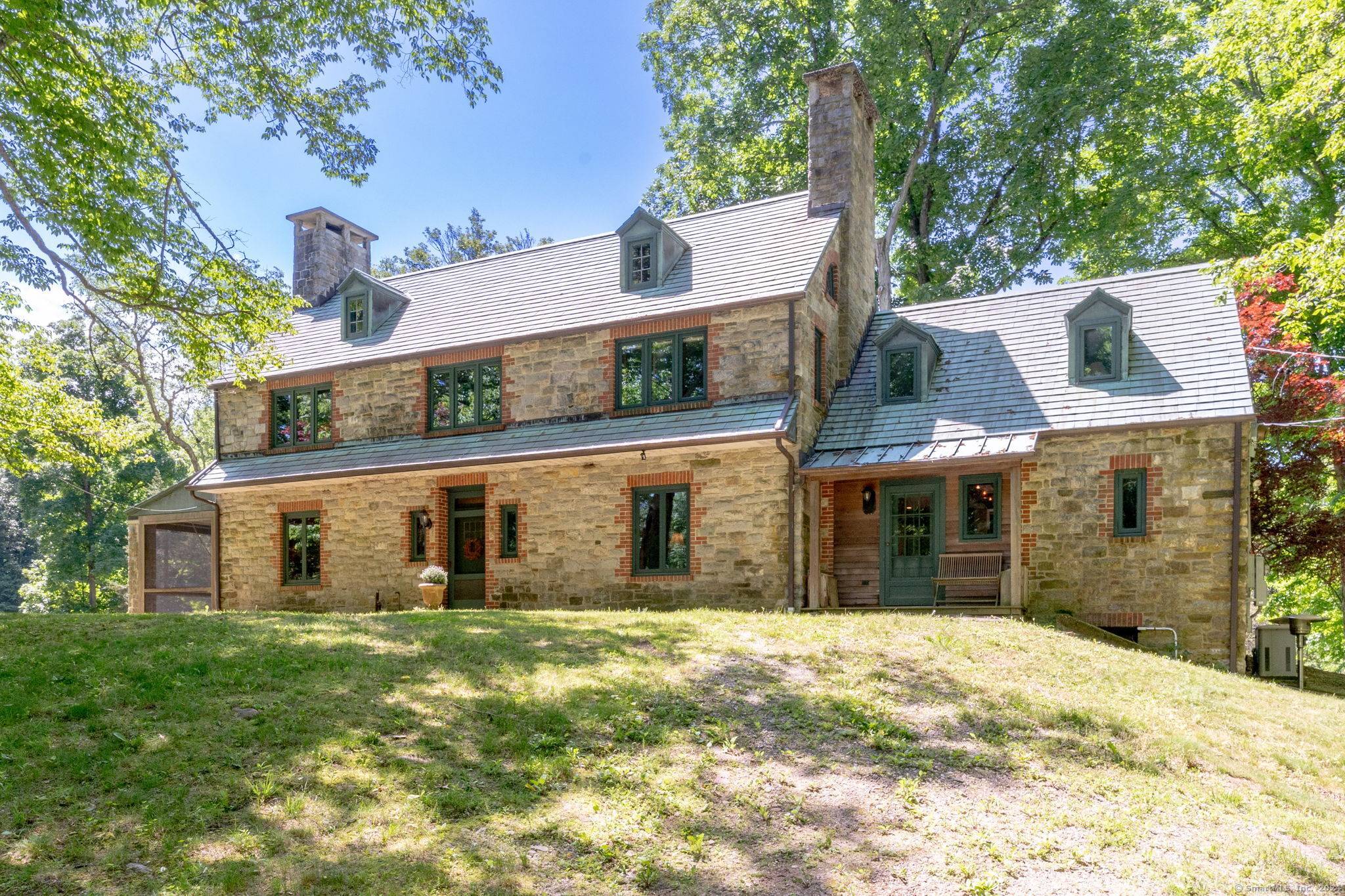 Originally designed and custom built on site with stones from property for local Doctor as a private English style hunting cottage in 1922.