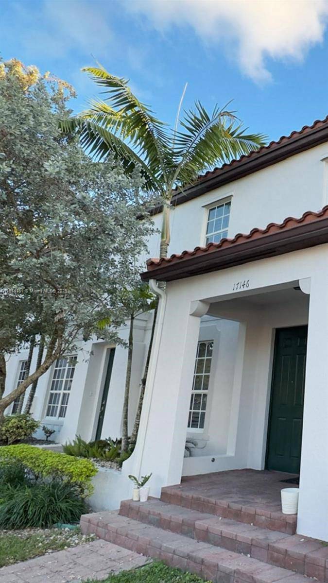 Spacious 4BR 3BA townhouse with double garage, driveway, front porch, and upgraded features throughout.