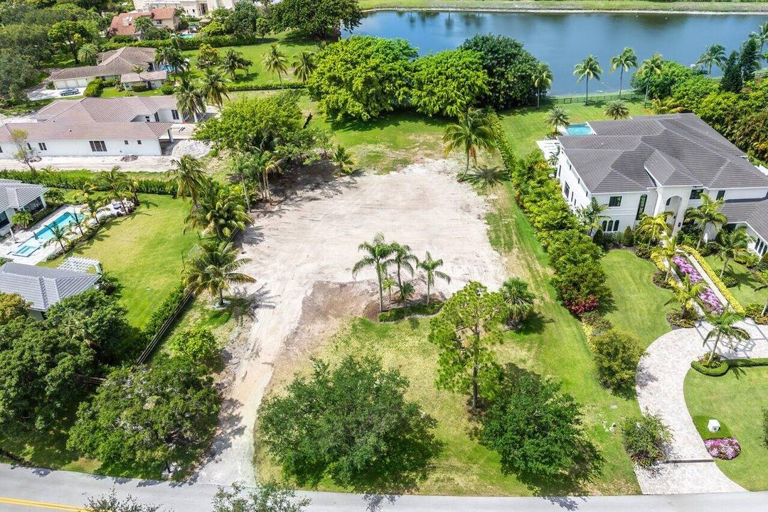 Build your dream home on this spectacular property with a gorgeous water view on over an acre surrounded by mature trees and landscaping.
