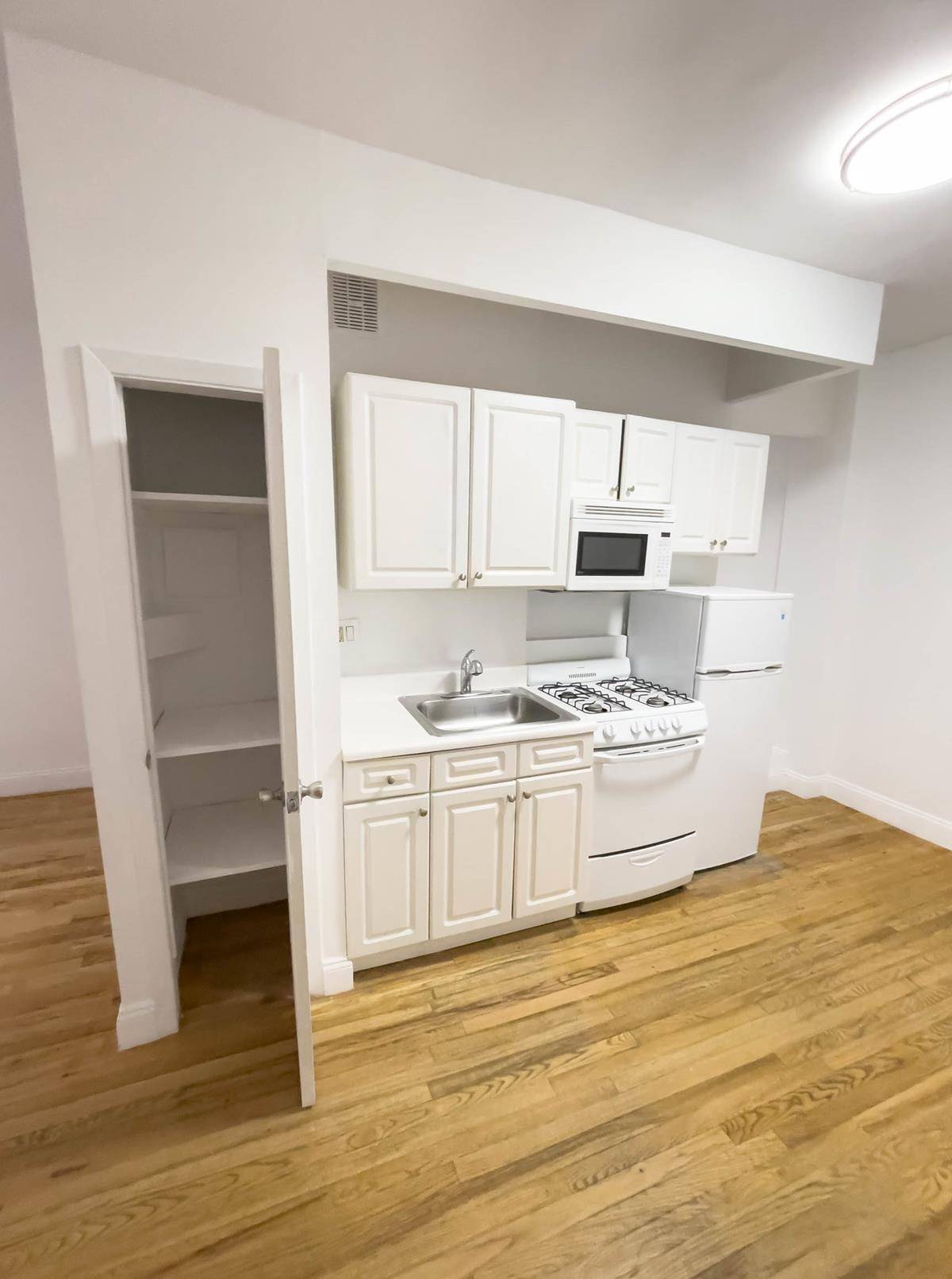 Beautiful alcove studio with renovated kitchen, including microwave, hardwood floors and high ceilings in a well kept low rise building.