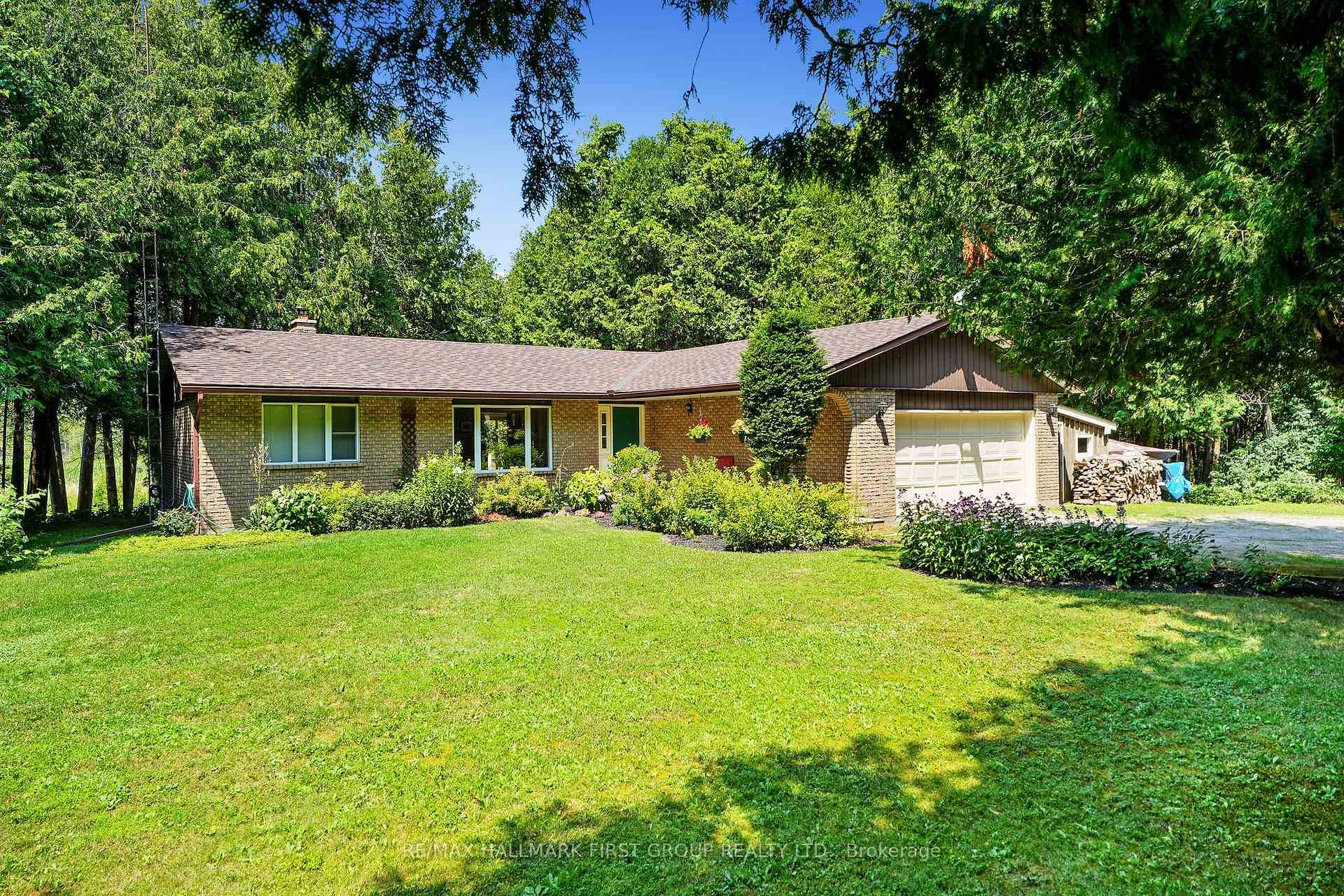 Classic charm meets country living in this timeless brick bungalow on 25 forested acres.