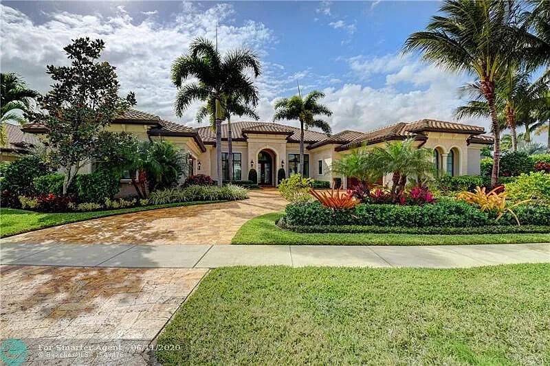 Experience unparalleled luxury in this exquisite one story estate on a coveted waterfront point lot in The Bridges, Delray Beach, FL.