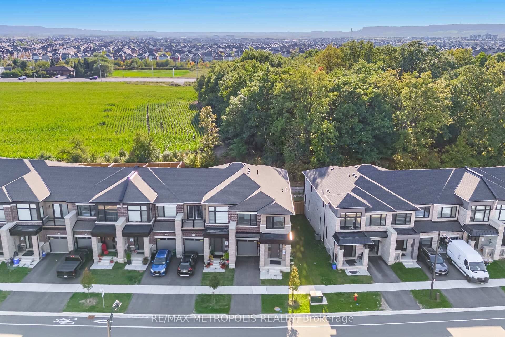 Discover this stunning end unit 2 storey townhome nestled on the green and backing onto serene woods in a highly desirable, newly developed Milton neighborhood.