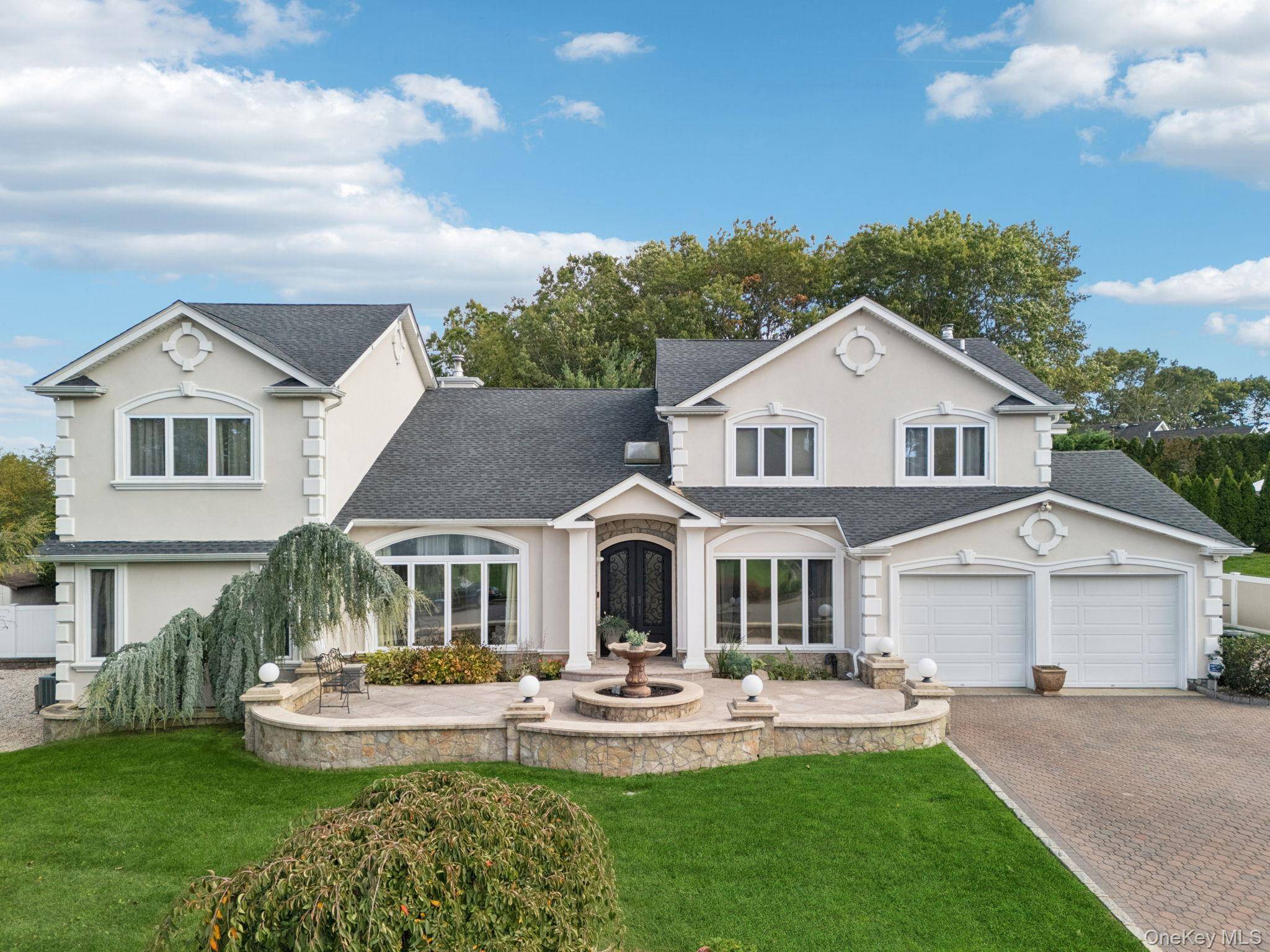 Located in the prestigious Country Woods Estates of Commack, this custom expanded five bedroom, five bath Colonial blends Old World sophistication with modern luxury.
