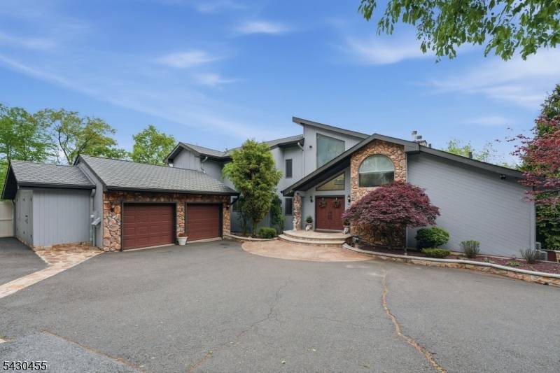 Perched high in Totowa's prestigious Dey Hill section, this expansive custom contemporary offers the privacy, space, views, and lifestyle today's North Jersey buyers are searching for.