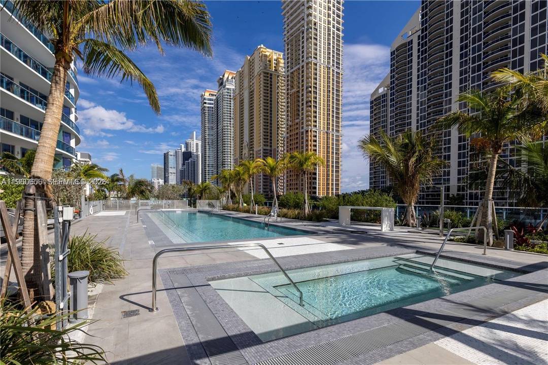 Experience elevated island living in this exceptional corner residence at Aurora a boutique luxury building offering only 61 exclusive residences in the heart of Sunny Isles Beach, just steps from ...