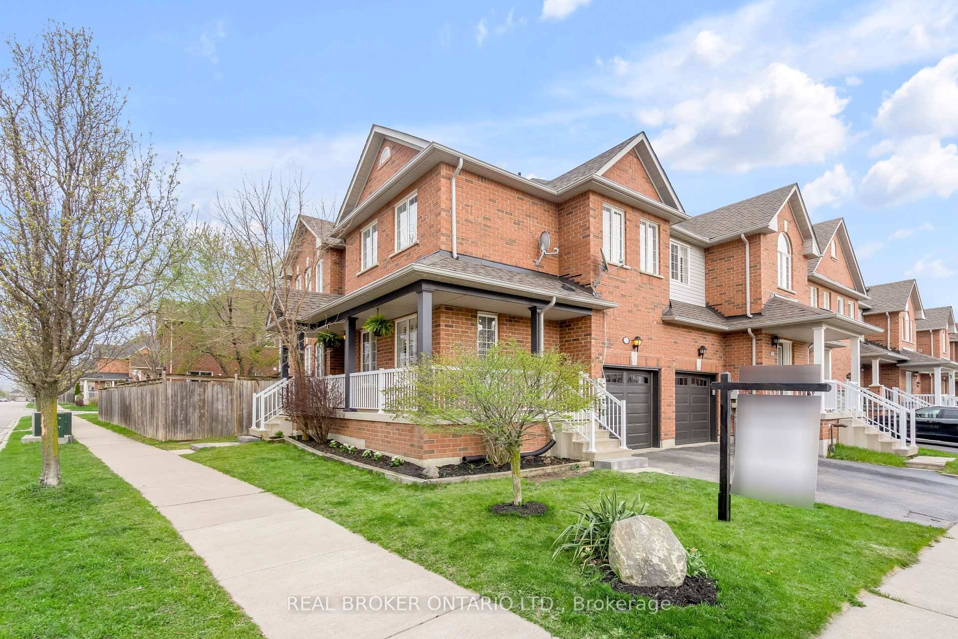 This bright end unit townhome offers standout features inside and out a charming wraparound porch, new garage door, and a larger private backyard with mature trees and a stamped concrete ...