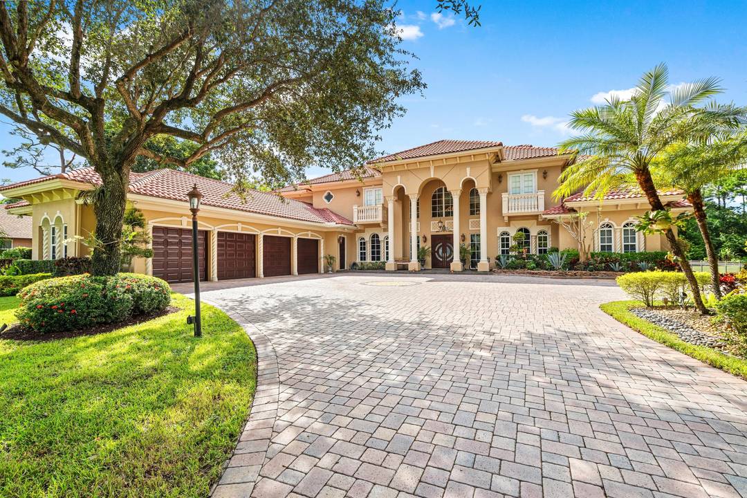 On more than an acre of meticulously maintained landscaping, the paver driveway leads to the impressive front entrance creating a welcoming first impression.