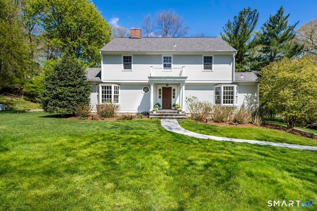 Set on a beautifully landscaped acre along one of Darien's most coveted residential lanes, 10 Queens Lane is a timeless 4 bedroom, 2.