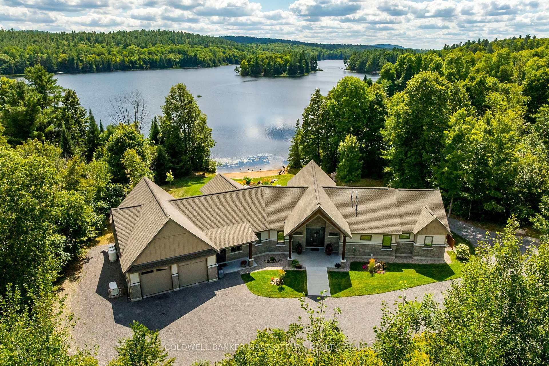 Welcome to prestigious Barrett Chute Estates and this custom 3 bedroom bungalow nestled amongst lush trees along the beautiful Madawaska River.