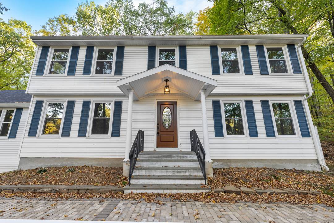 Built to Last ! Welcome to 545 Simsbury Road, a striking and versatile residence set on a private, wooded 3.