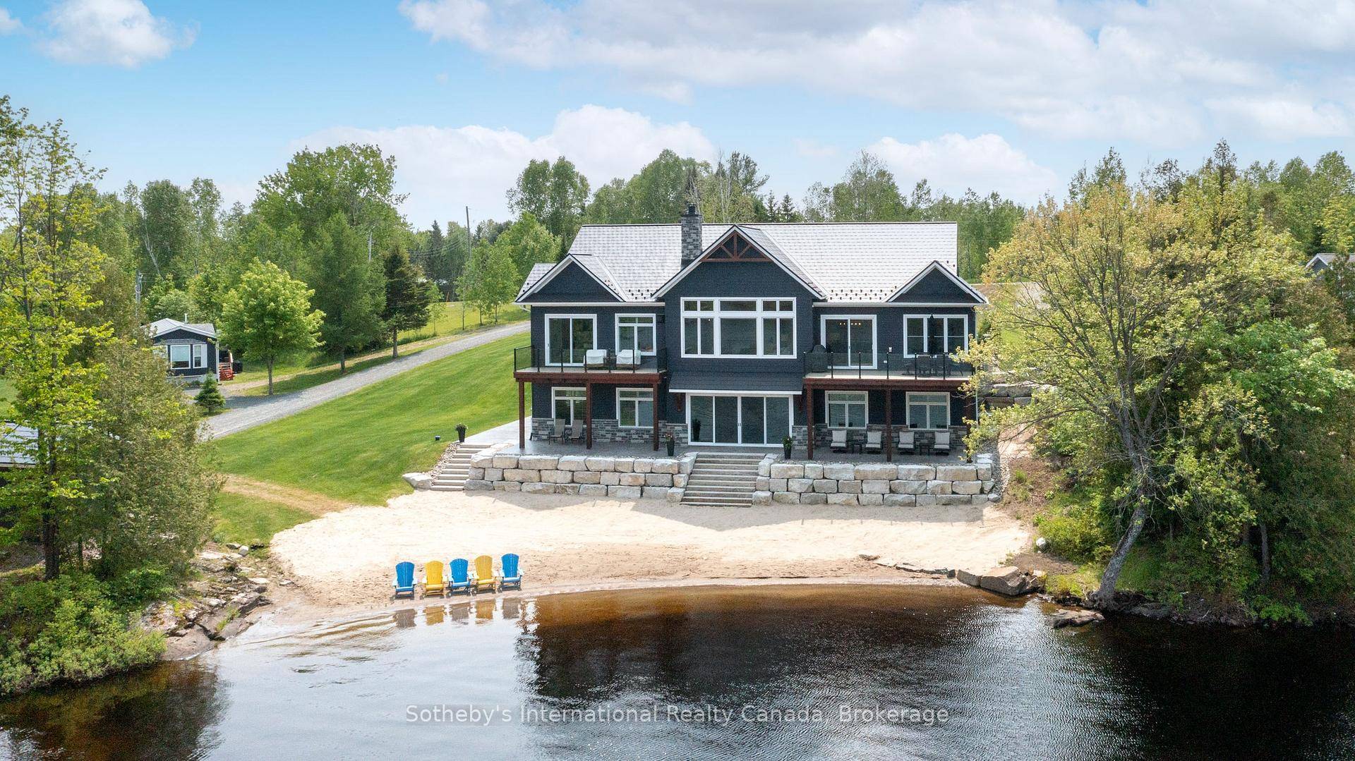 Welcome to 19 Bears Paw, a standout luxury cottage drenched in all day sun offering 175 feet of clean, sandy shoreline on sought after Whitestone Lake.
