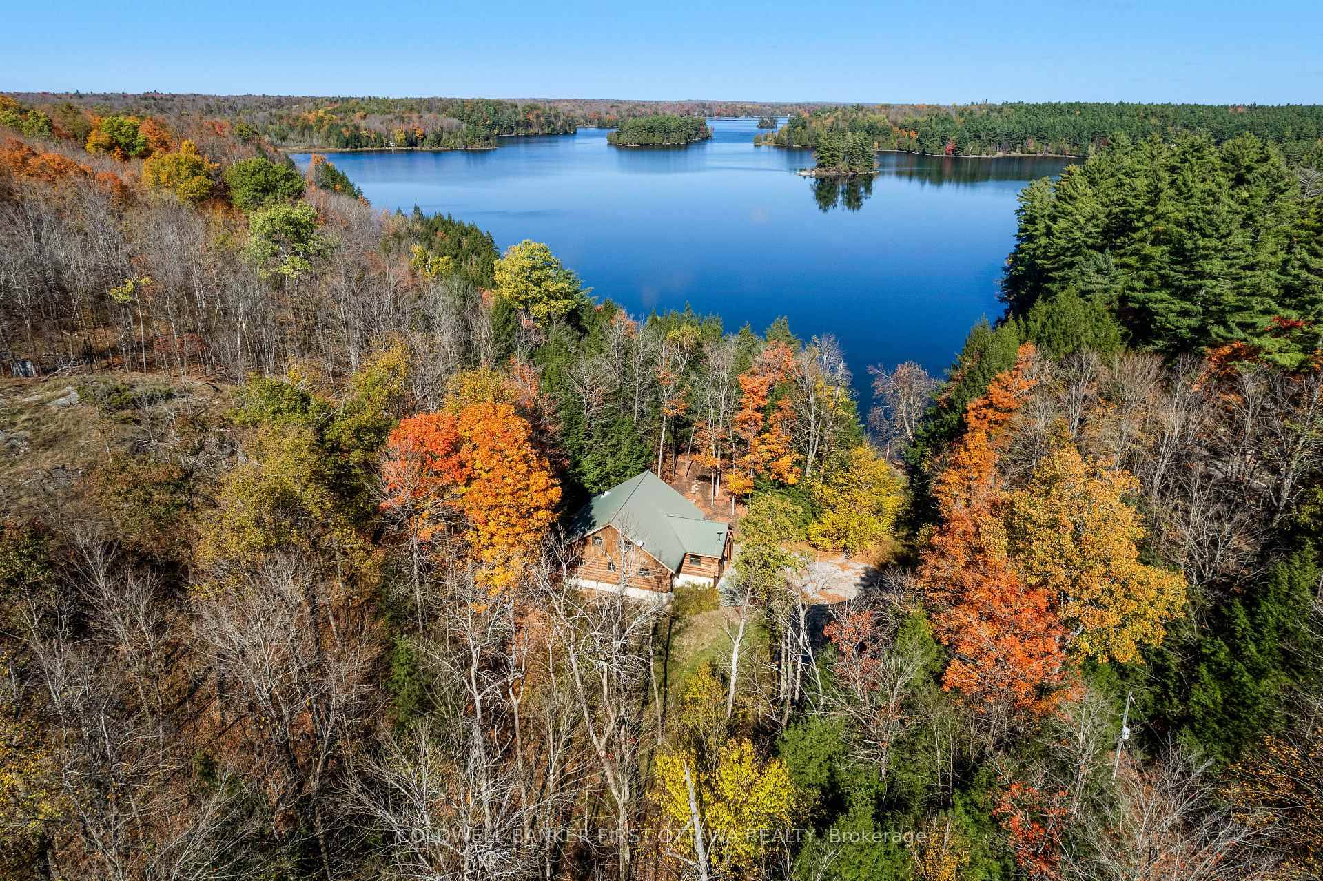 Lakefront luxury living on 6 lovely acres along Bennett Lake.