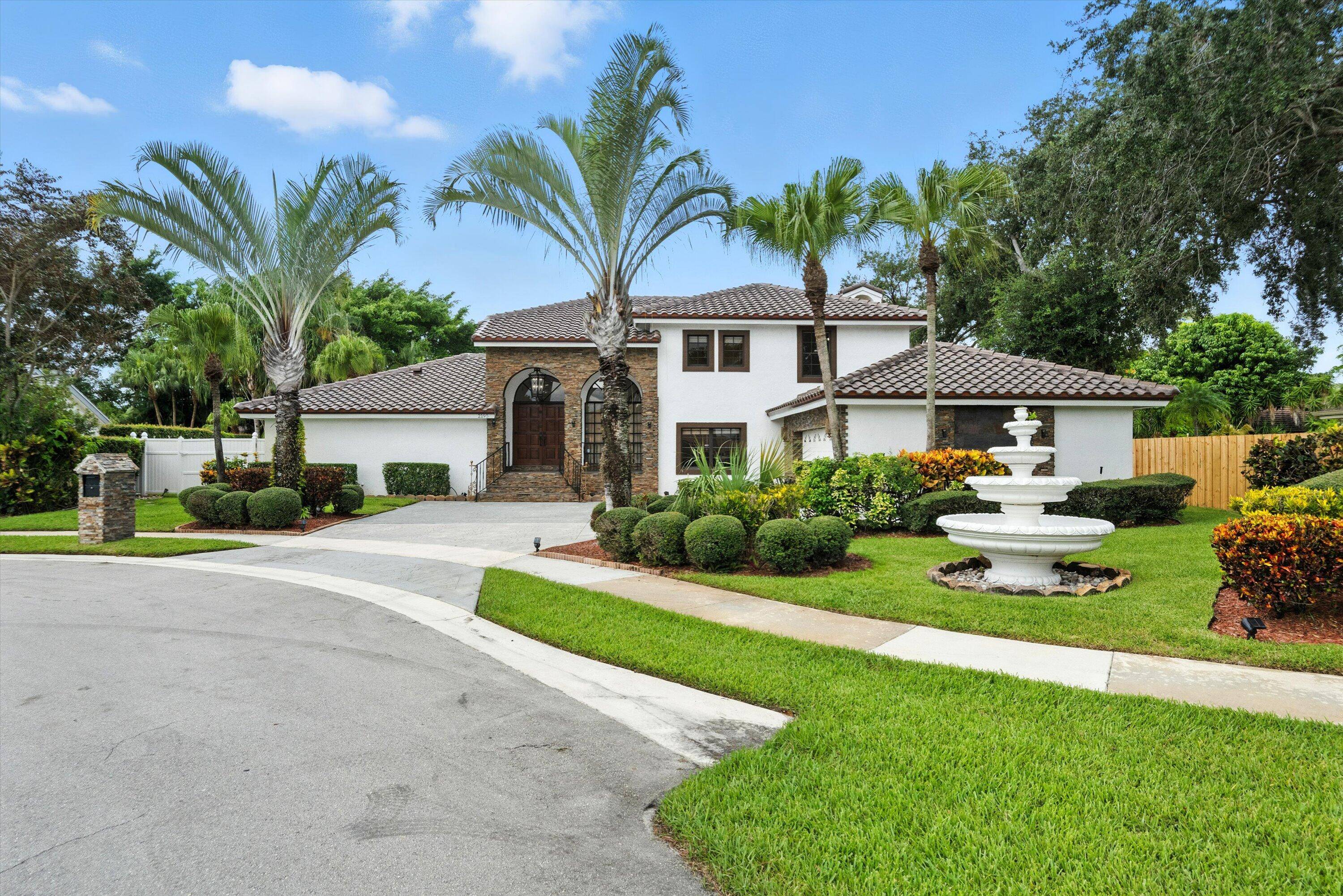Welcome to this Mediterranean style retreat in the heart of Wellington, FL, perfectly situated on a quiet cul de sac with sweeping waterfront views and a private oversized boat dock.