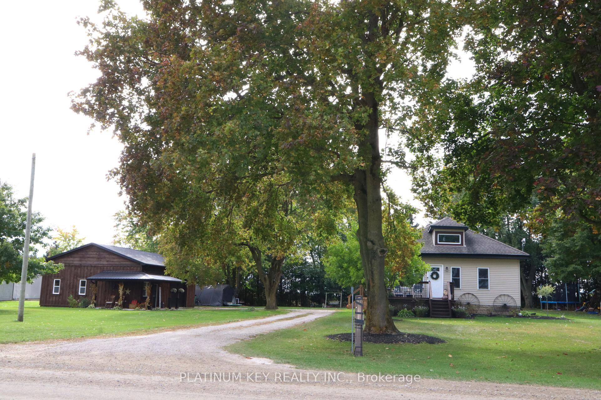 Discover your dream retreat in this beautifully renovated bungalow, renovations completed in 2024, nestled on a serene acre of treed land with new 2025 rear deck.