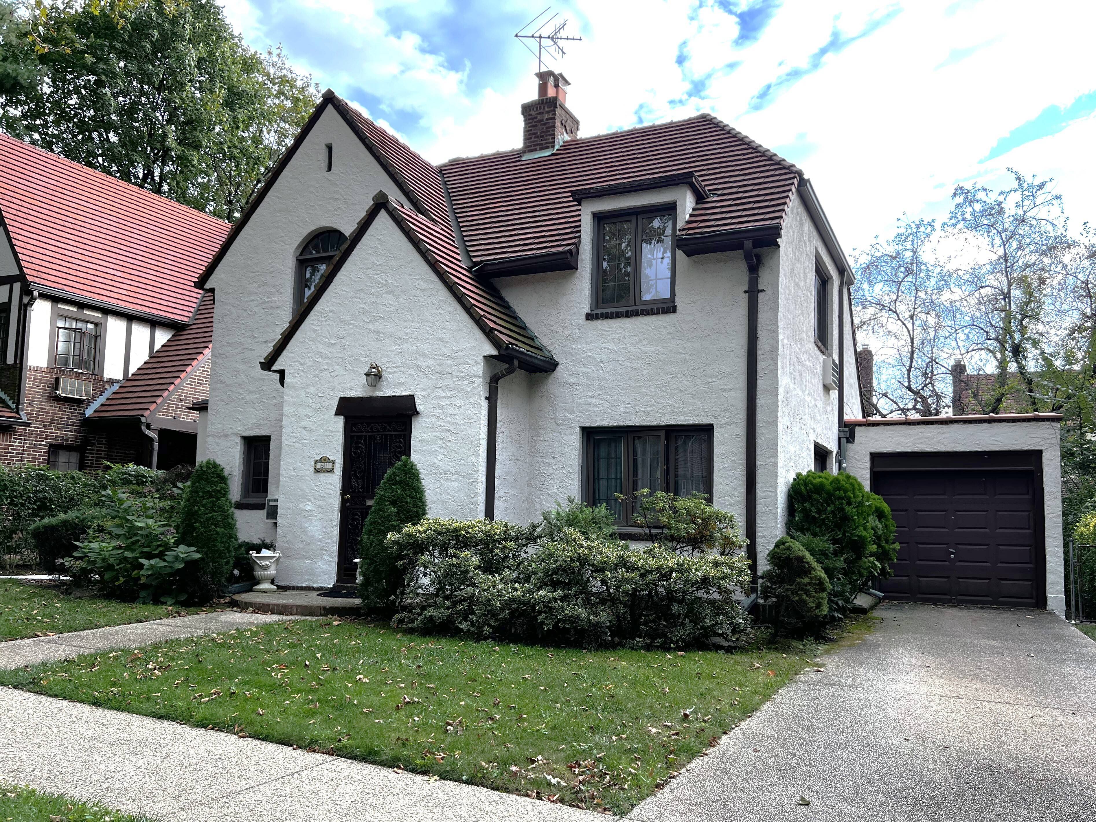 Beautiful detached Tudor in prestigious Forest Hills Gardens featuring 4 bedrooms and 3 full baths, including a first floor bedroom and bath ensuite.