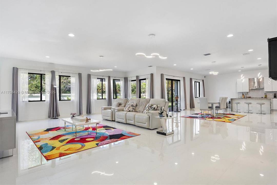 Step into refined living at this stunning home in the gated Marbella Miramar community.