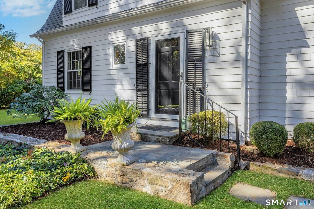 Step into timeless charm with this quintessential Dutch Colonial, gracefully nestled on a breathtaking parcel in one of the most sought after neighborhoods, Ox Ridge.