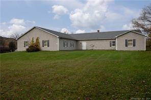 Prime commercial building with large office space, two bathrooms, break room and five large workshop rooms.
