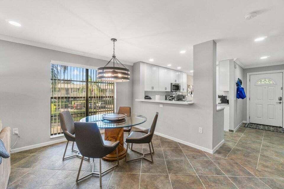 Experience the epitome of modern elegance in this fully remodeled 2nd Fl corner condo.