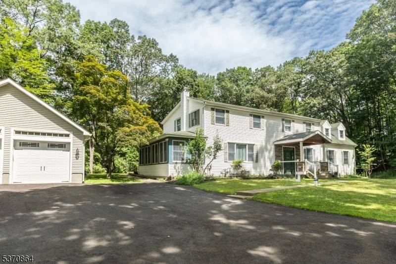 Discover the charm of this custom home, perfectly set on over 2 acres of private, wooded property.
