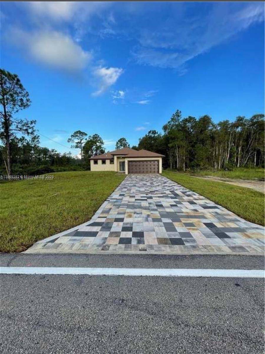 Beautiful 4 Bed, 2 bath home features a spacious open floor plan with outdoor views of a wooded area and screened paved lanai.