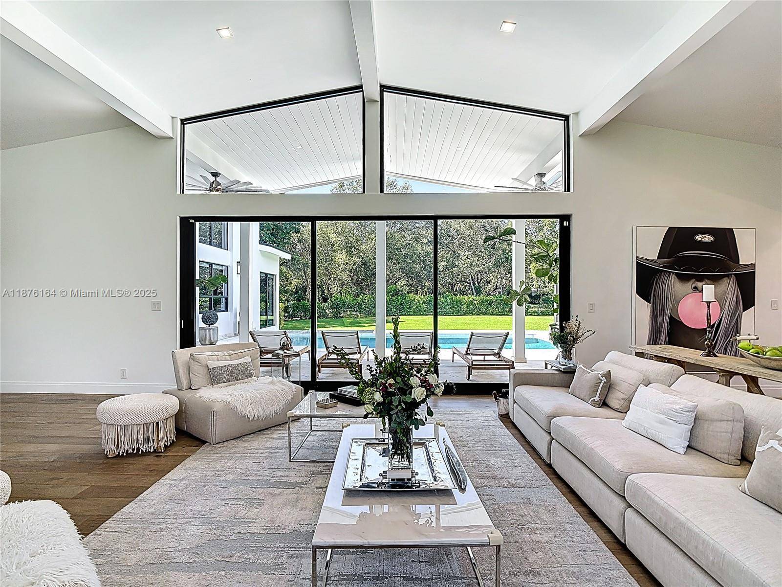 Nestled on over an acre of lush, private grounds in sought after Pinecrest, this stunning 5 bedroom, 5.