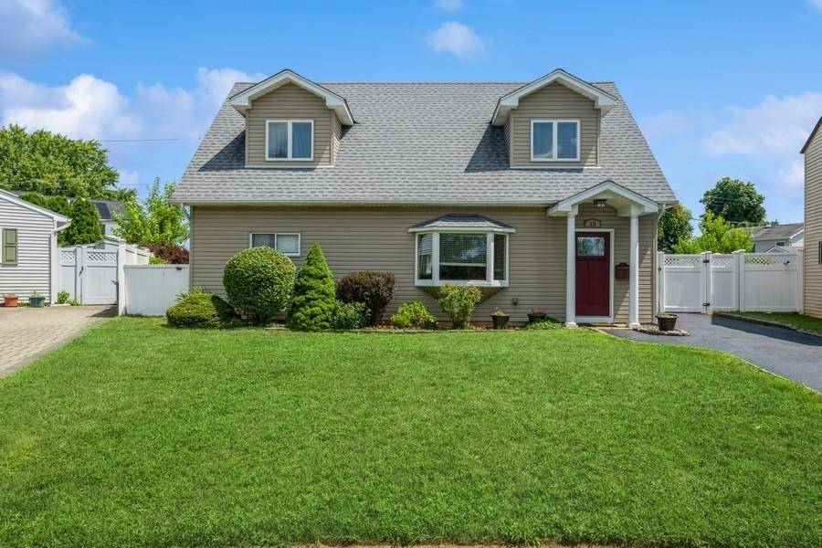 Welcome to 15 Budd Court a beautifully expanded Cape nestled on a quiet cul de sac in the heart of the Plainedge School District.
