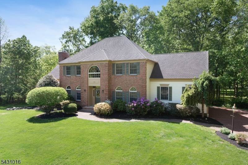 Nestled on a beautiful private and park like 1 acre wooded lot in sought after Montgomery Township, this well maintained four bedroom, 2.