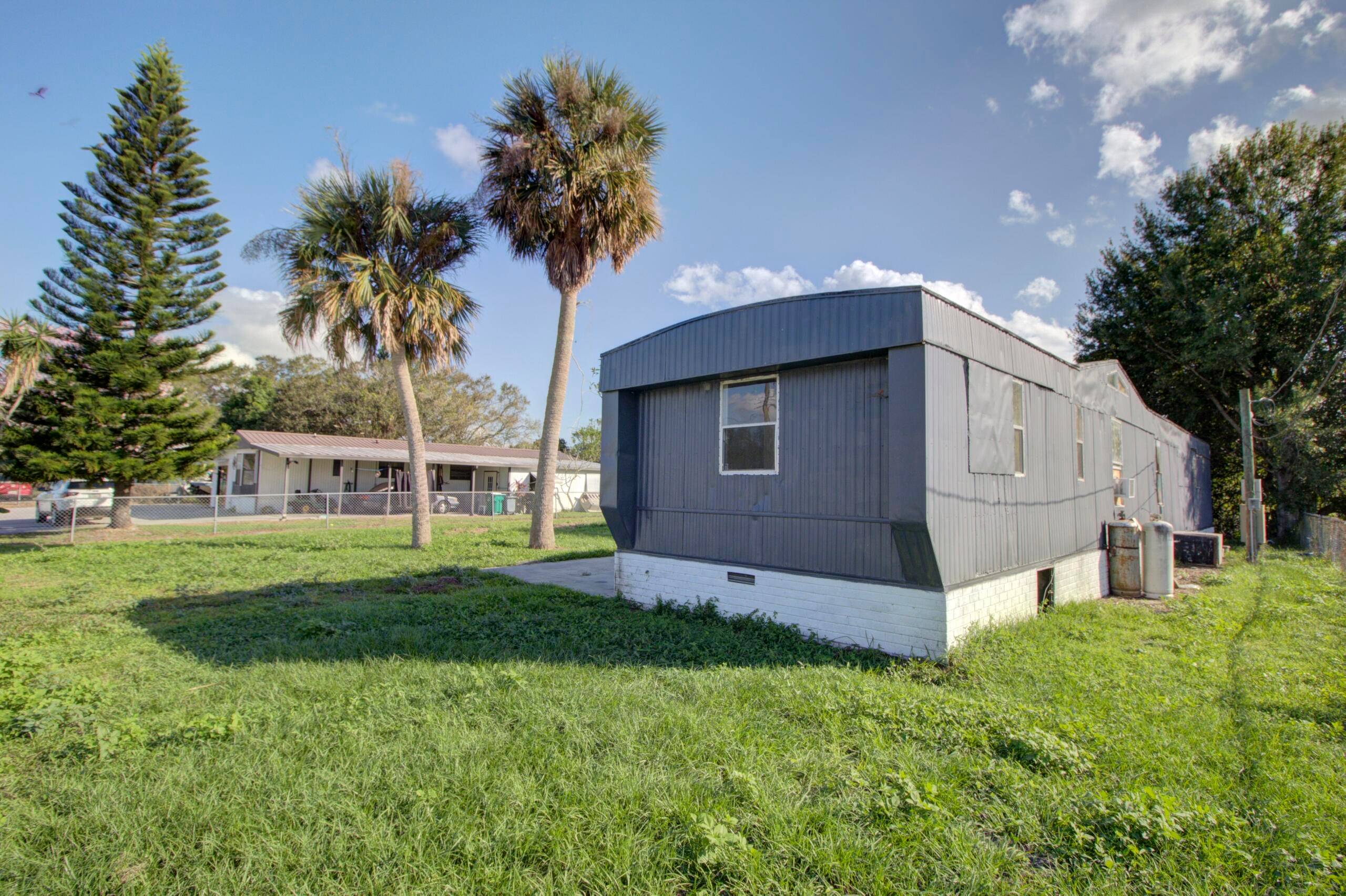Treasure Island Canal front 3 bedroom mobile home on a flat, cleared, fenced lot in Okeechobee.