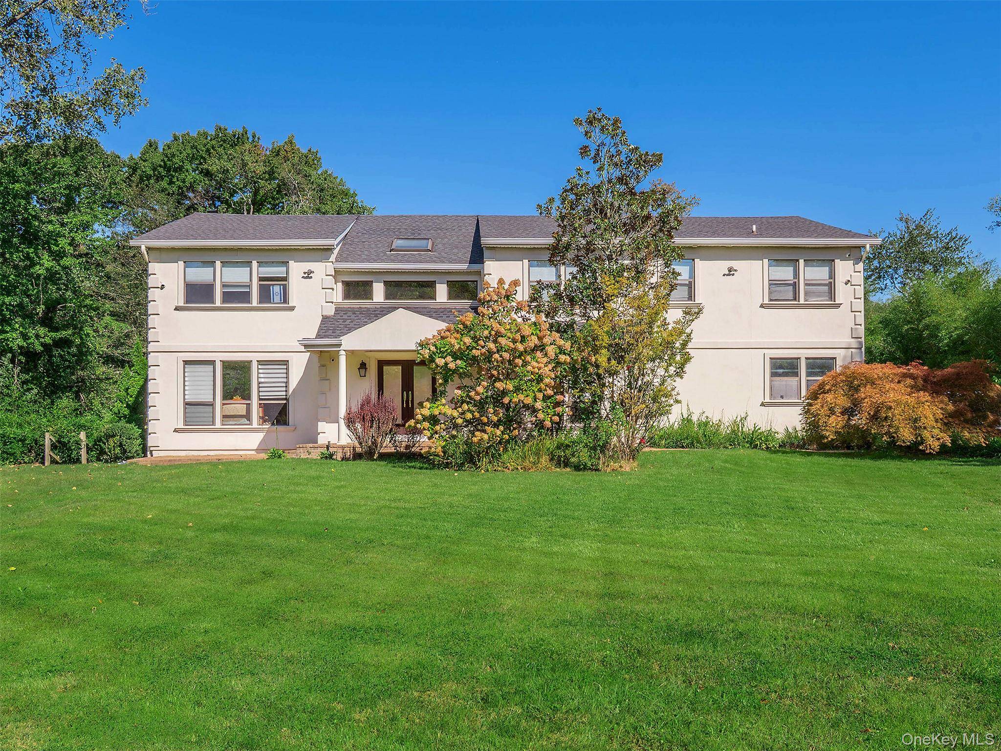 Welcome to this exquisite Center Hall Colonial located in the prestigious Village of Kings Point.