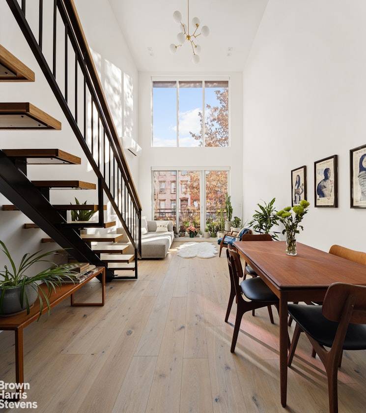Welcome home to this infinitely bright duplex with floor to ceiling windows, wide plank oak floors, two full bathrooms, and southern and northern exposures both with private balconies.